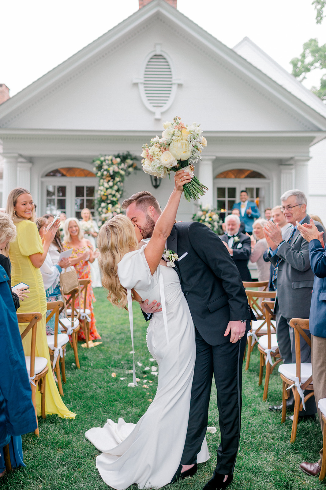 bride and groom kiss at estate garden wedding