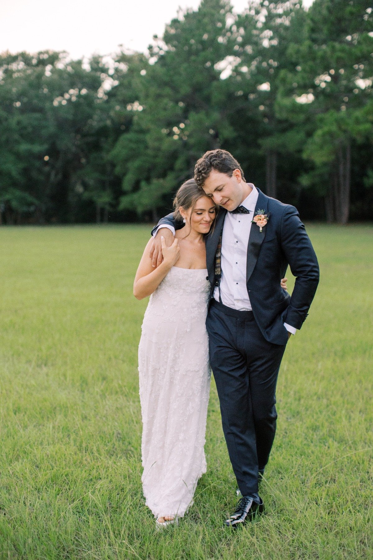 bride and groom walking outside with empire waist gown