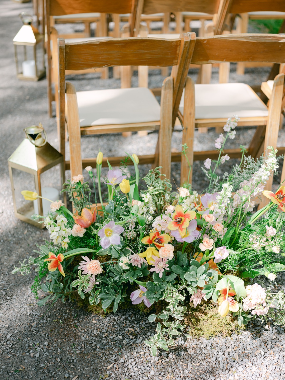 colorful floral arrangements on the floor for wedding ceremony