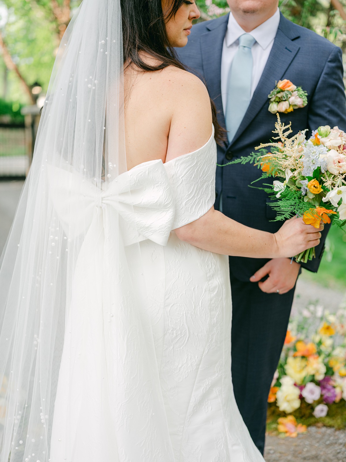 floral embossed wedding gown with bow cape and pearl veil