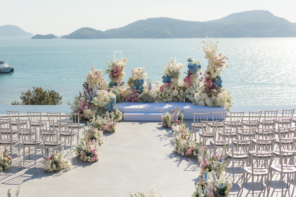 waterfront wedding venue in thailand with mountains in the background