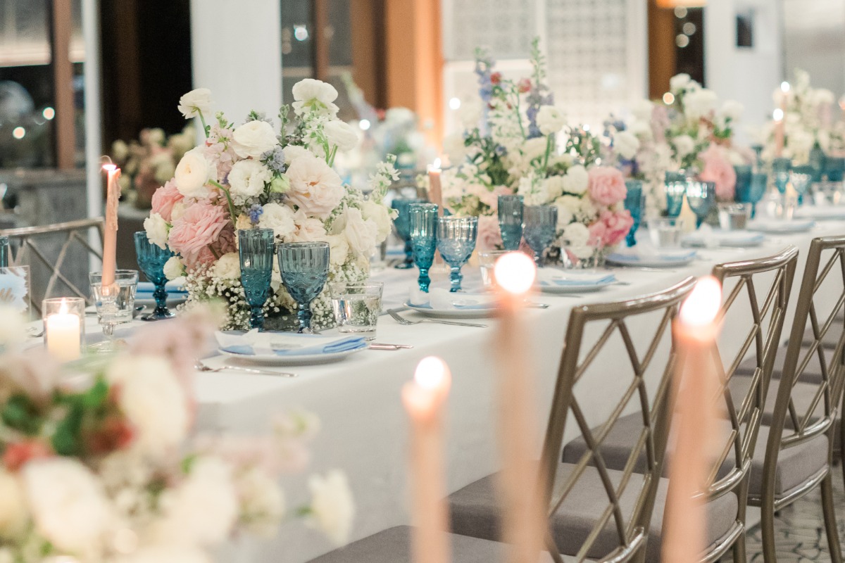 pastel candles and blue glasses for wedding reception