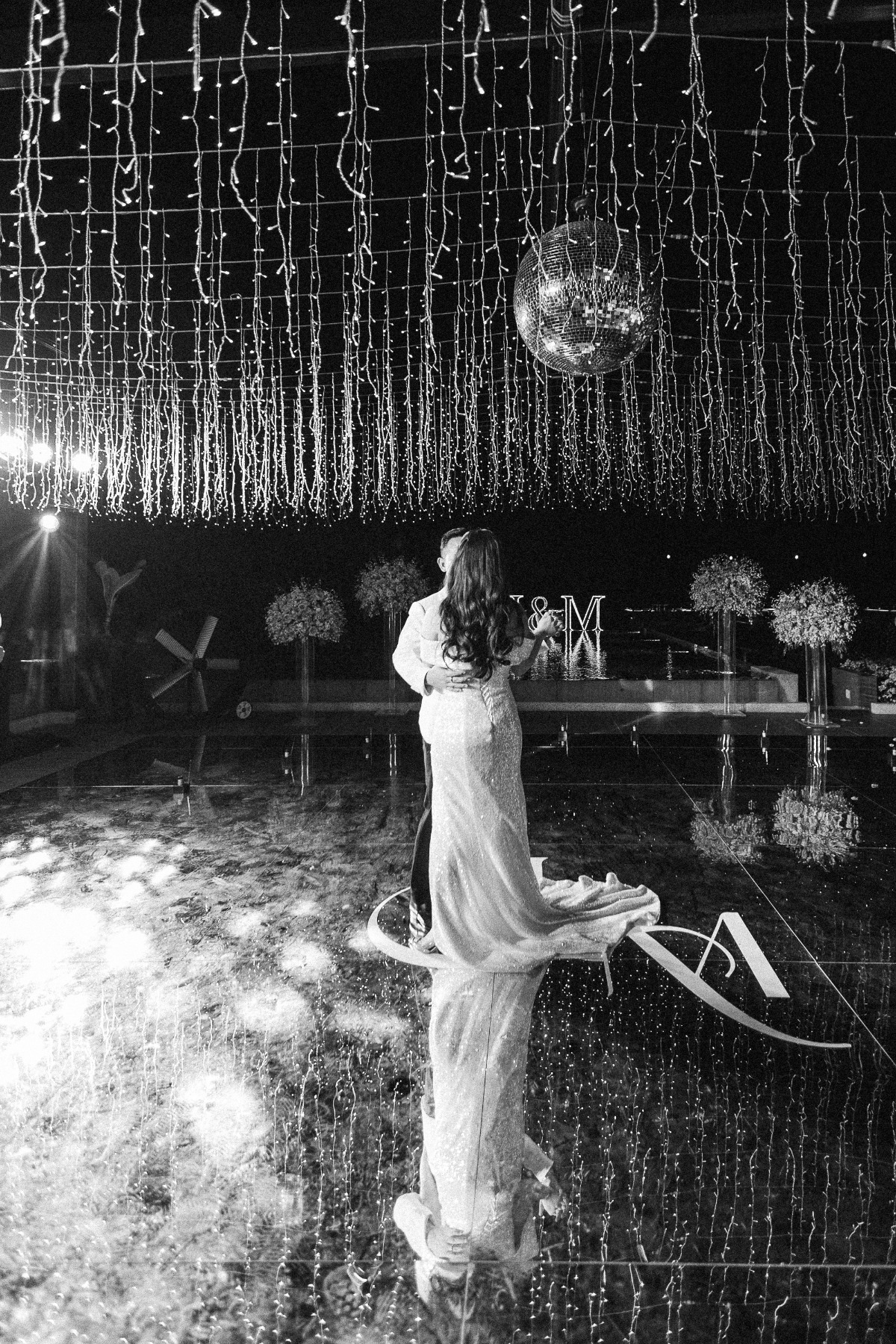 bride and groom dance on mirrored dance floor