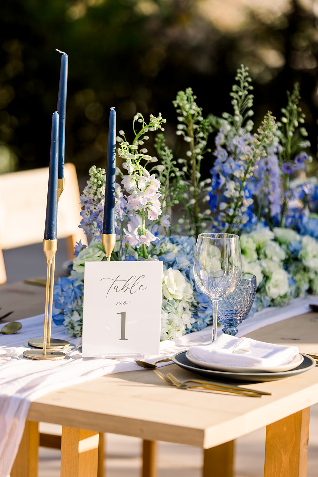 blue tapered candles in gold holders