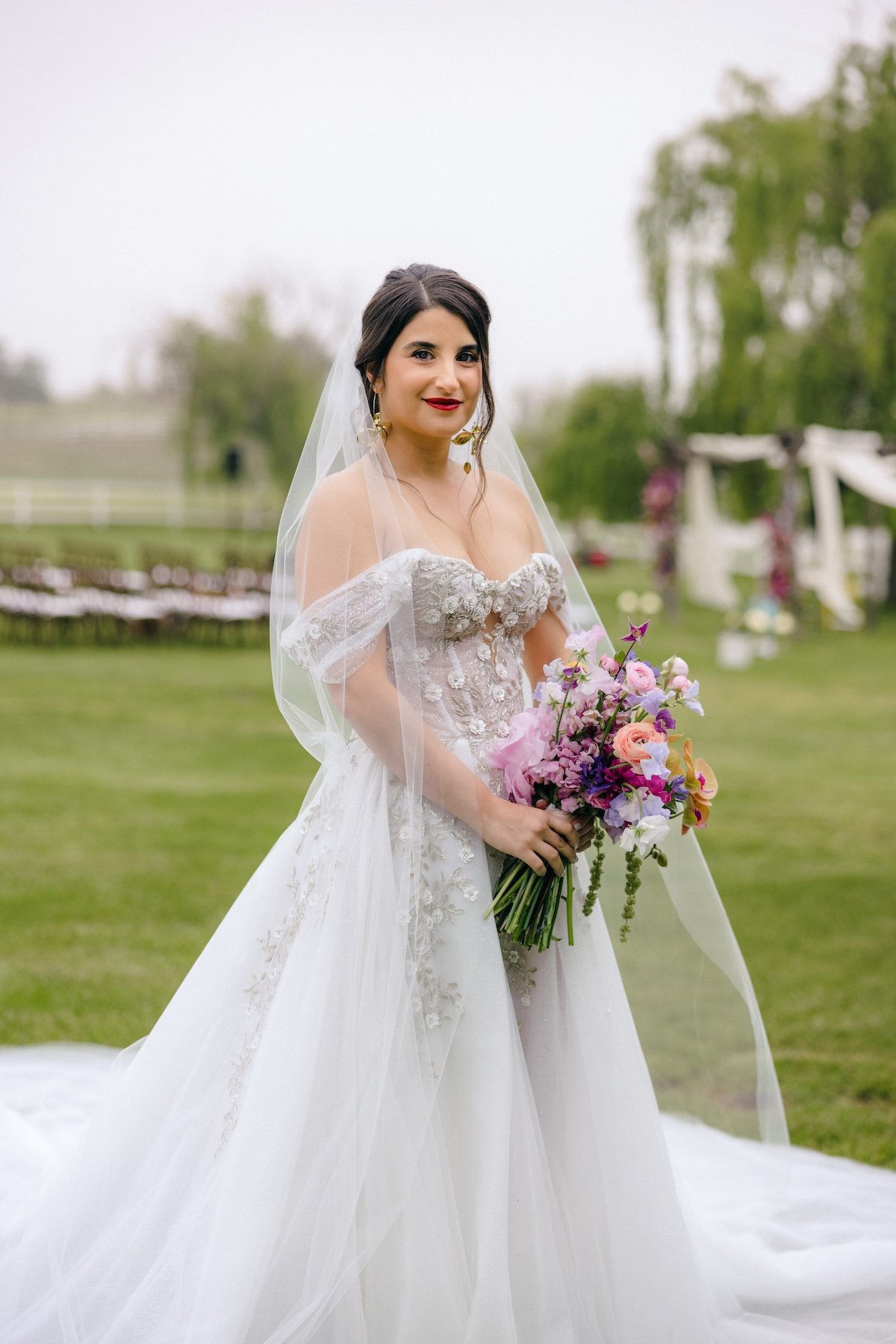 bride at ranch wedding holding bouquet