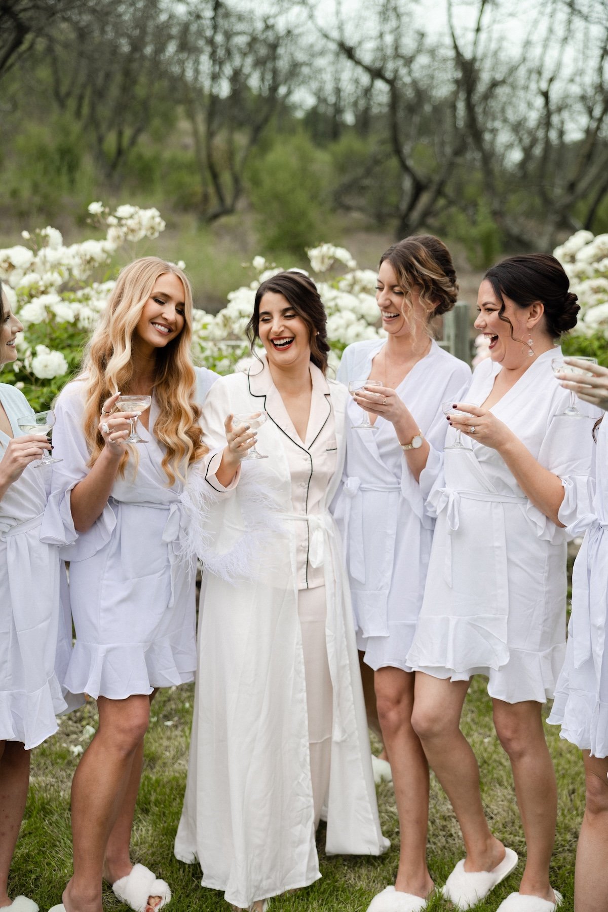 bride and bridesmaids in robes at ranch