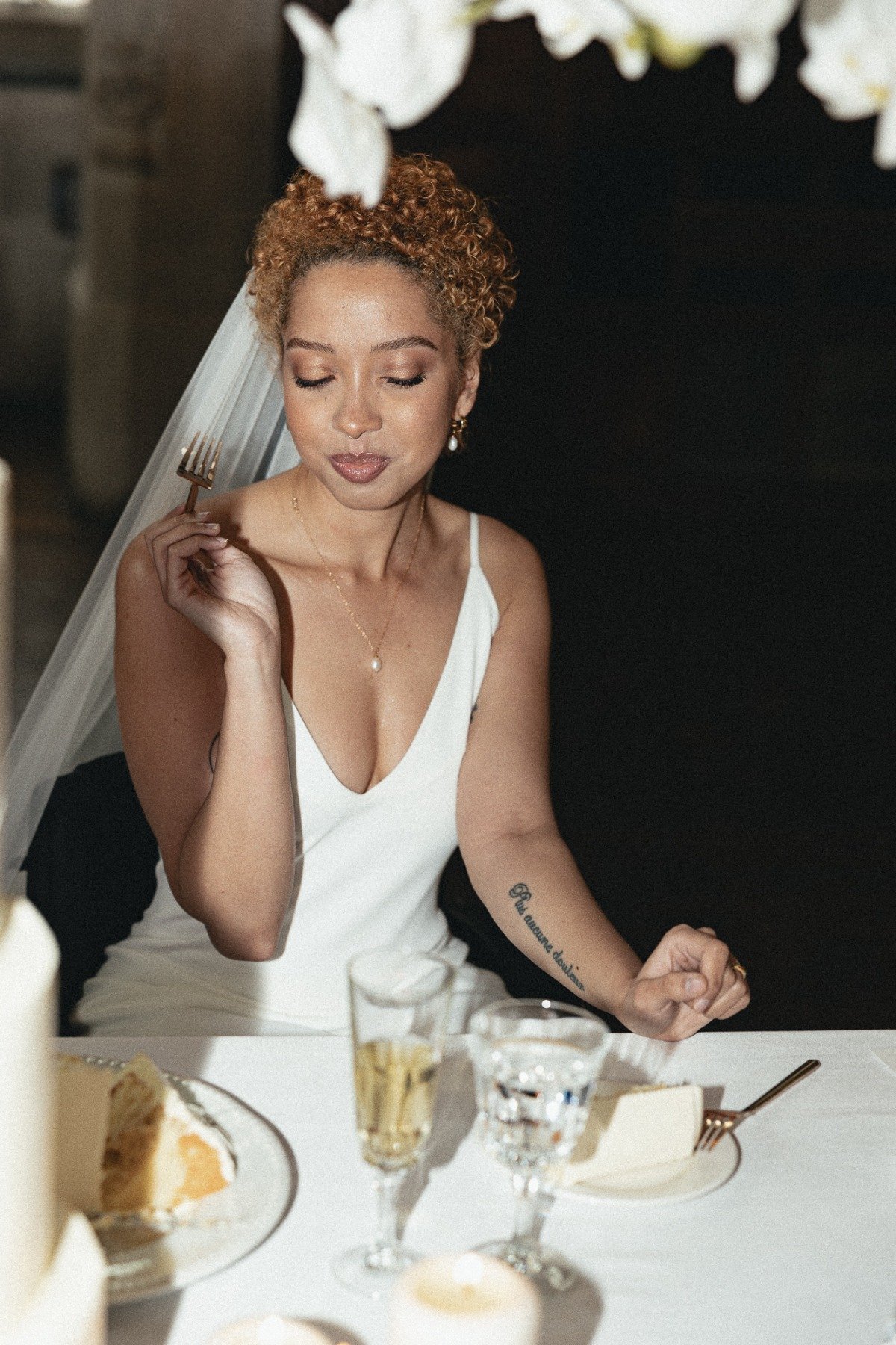 non-binary bride eating wedding cake