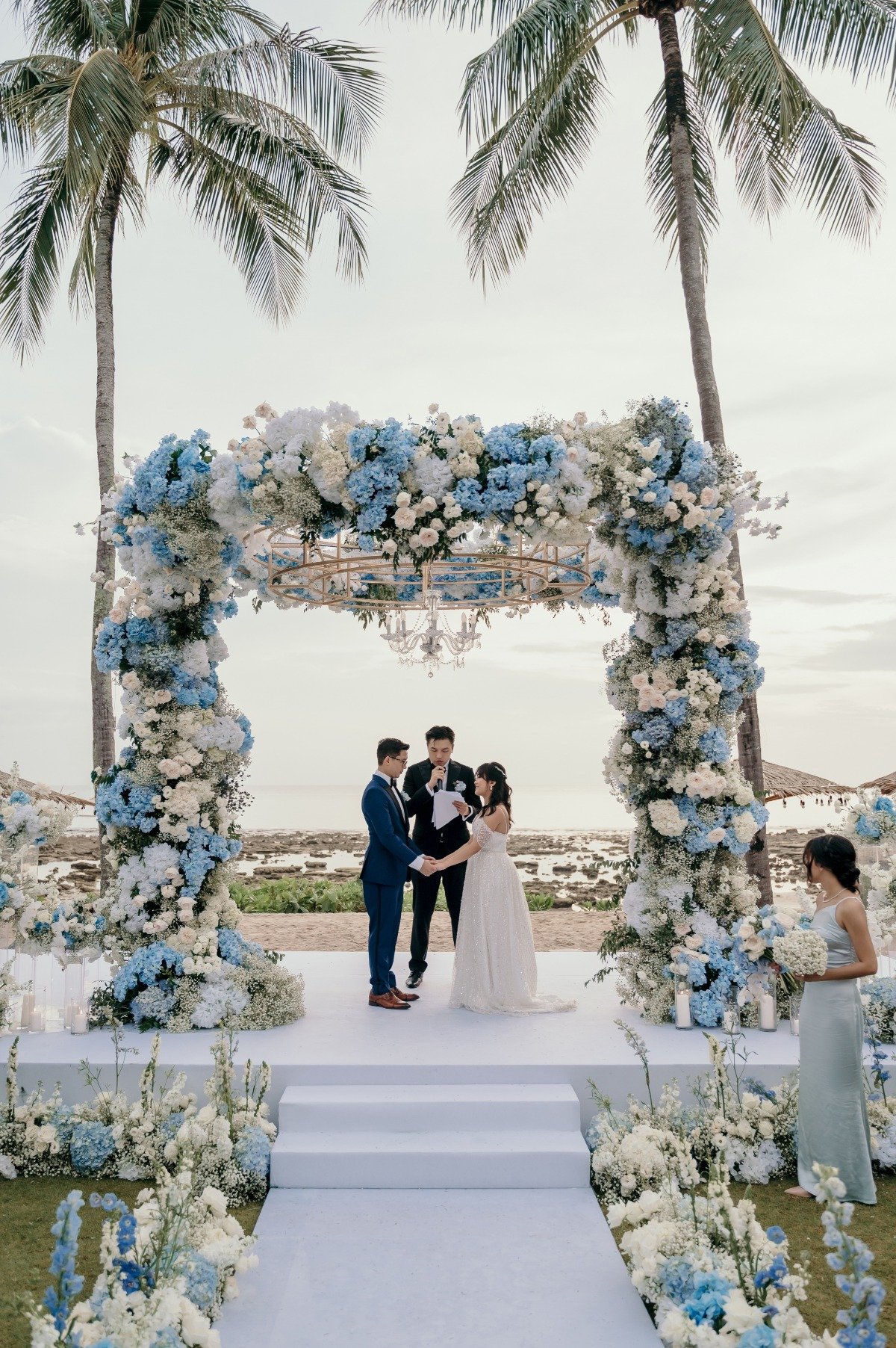 blue and white floral installation with chandelier