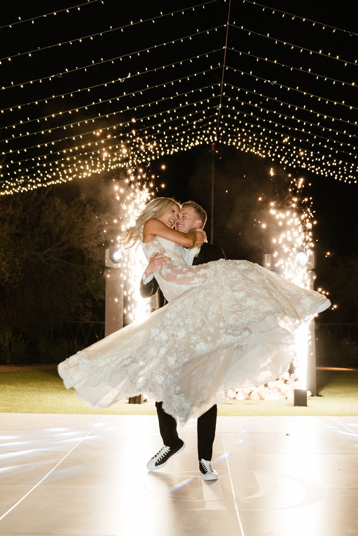 bride and groom dance at wedding reception with sparks