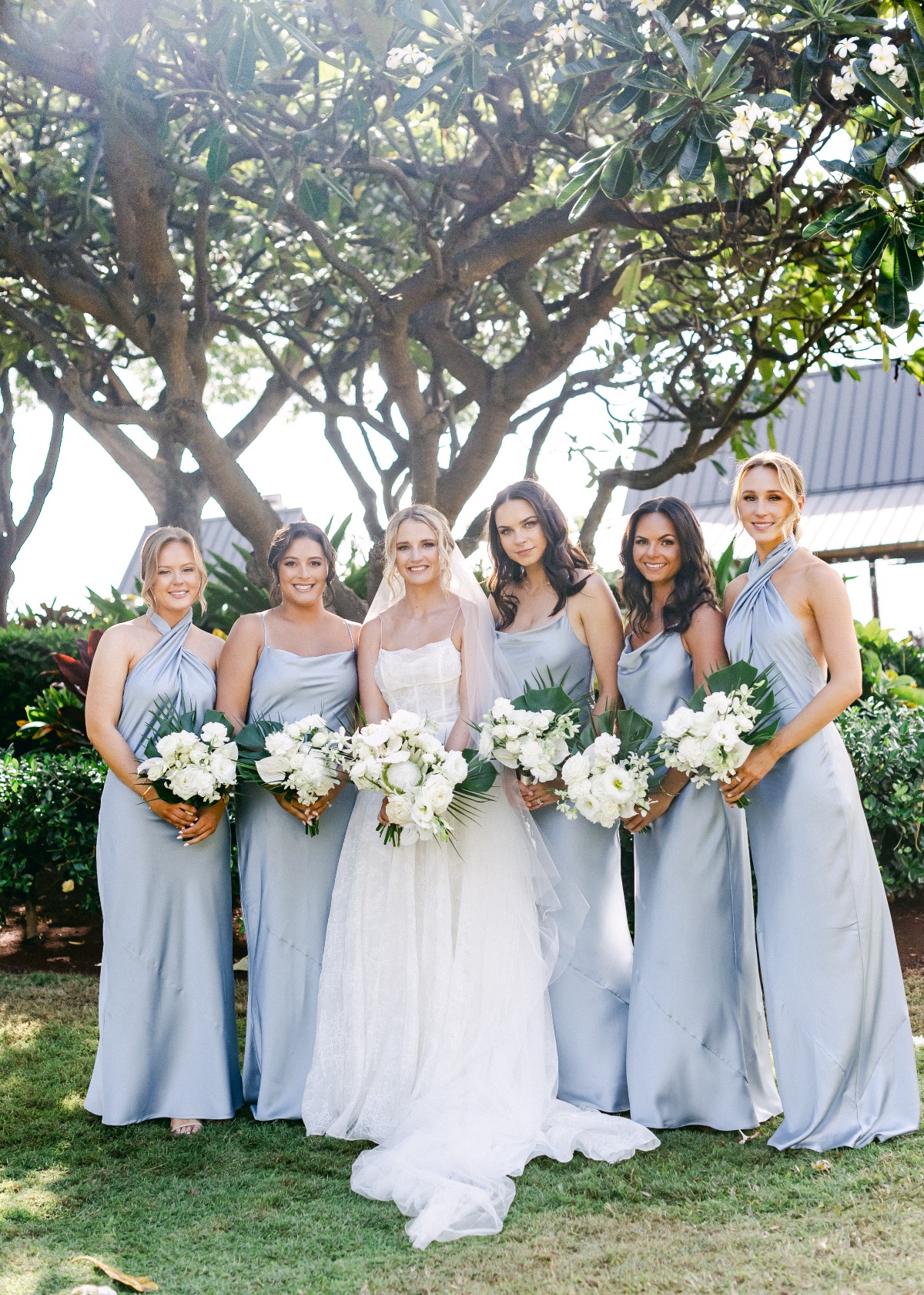 bridesmaids in mix and match blue satin dresses