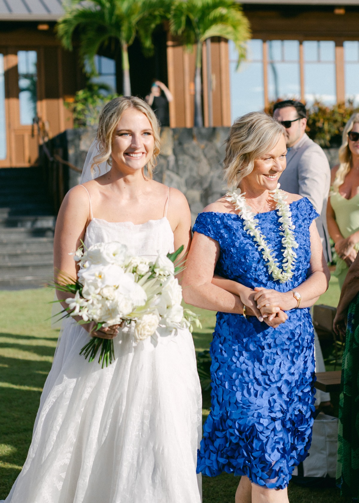 mother walking bride down the aisle in blue dress