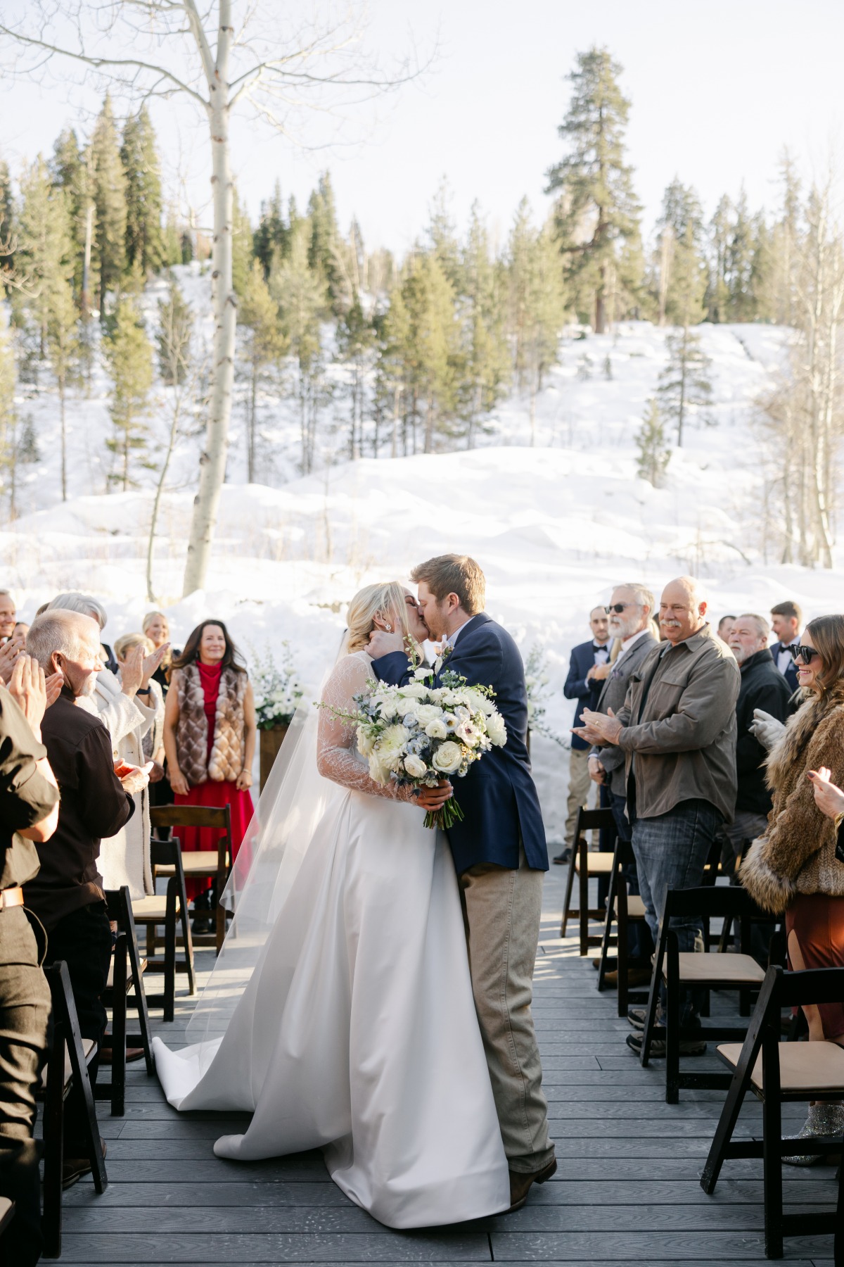 winter wedding ceremony kiss