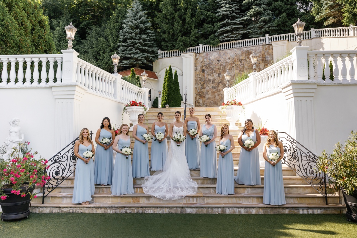 bride and bridesmaids on stairs at new york manor venue