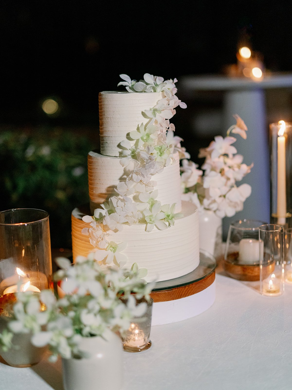 simple buttercream wedding cake with fresh flowers