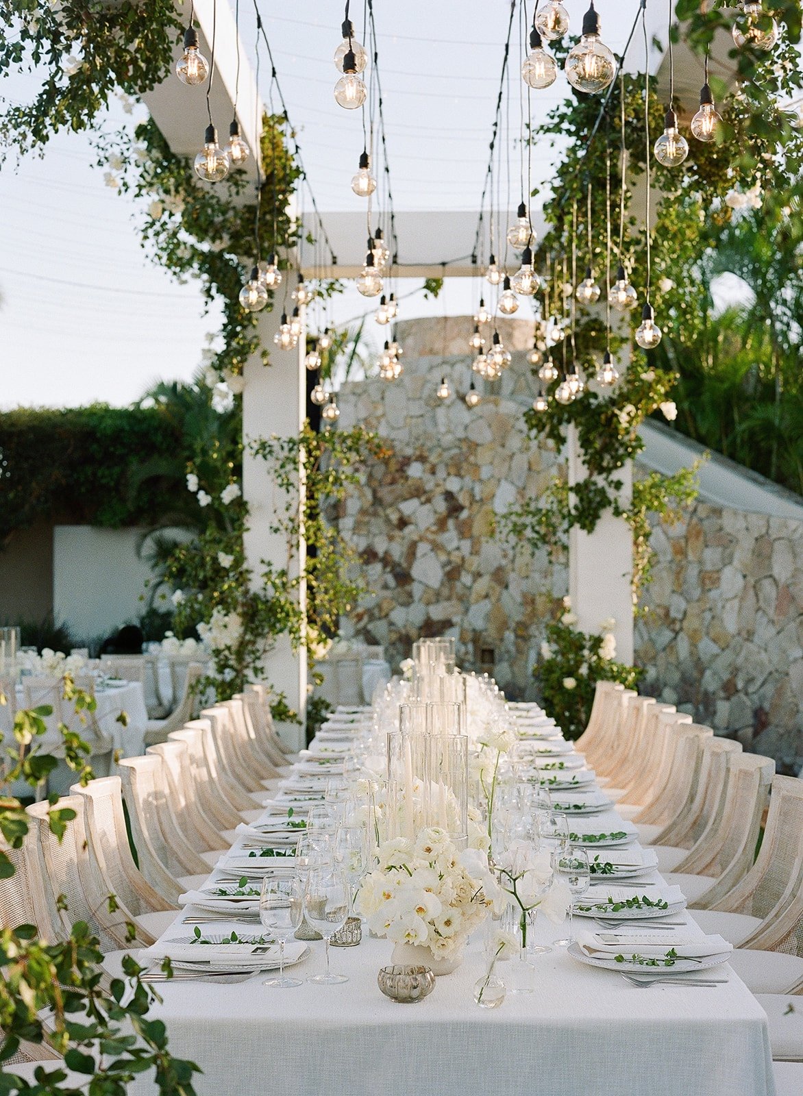 outdoor white wedding tablescape with candles