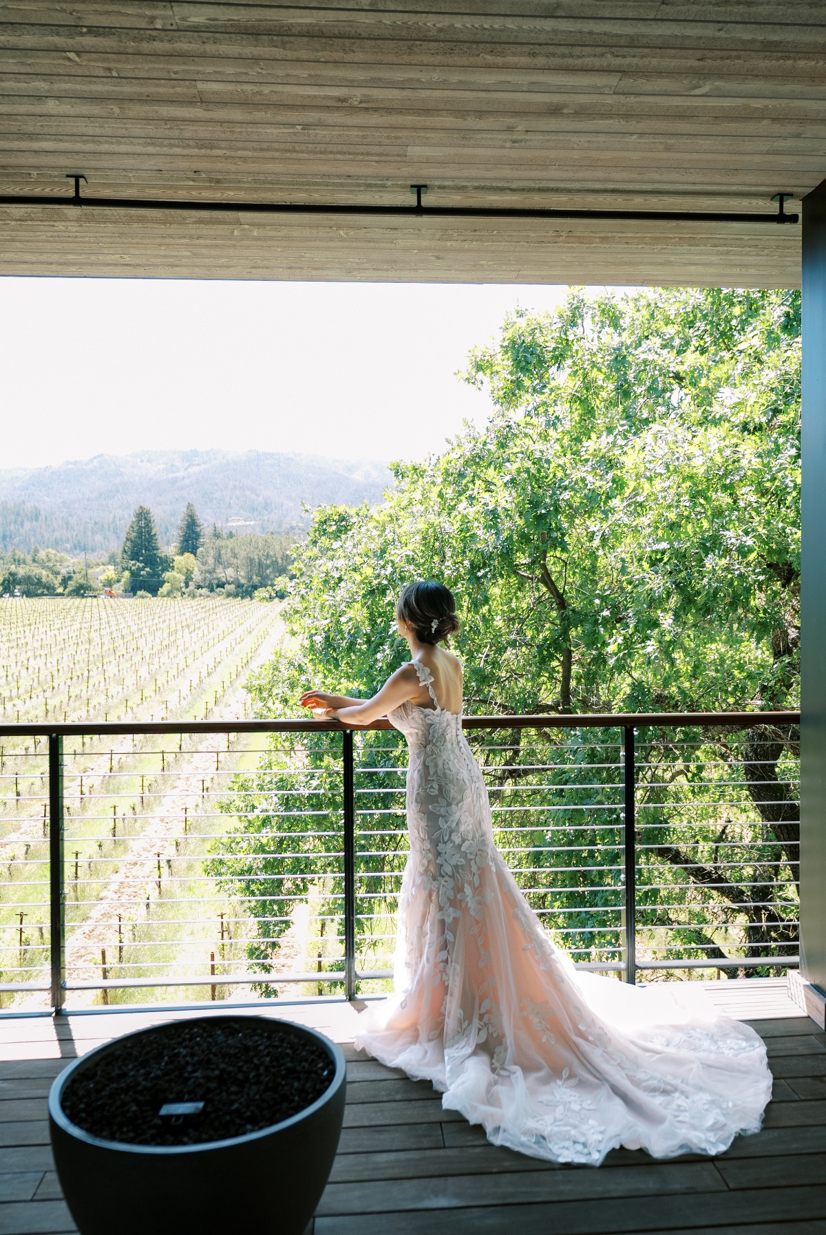 bride looking at vineyard as she gets ready for wedding