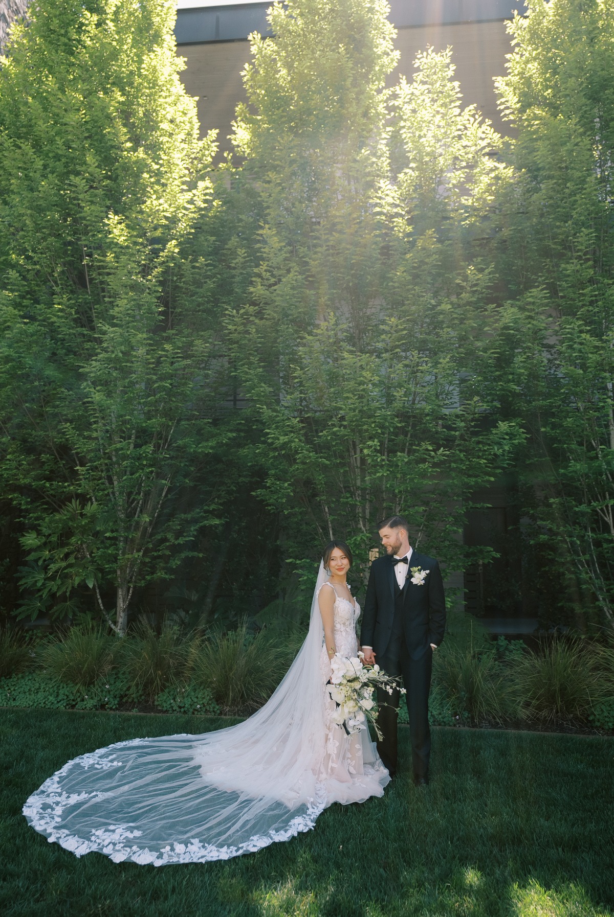 bride in lace gown with large white bouquet