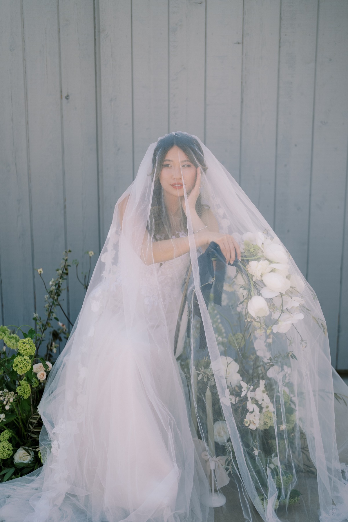 bride with veil over chair wedding photography ideas