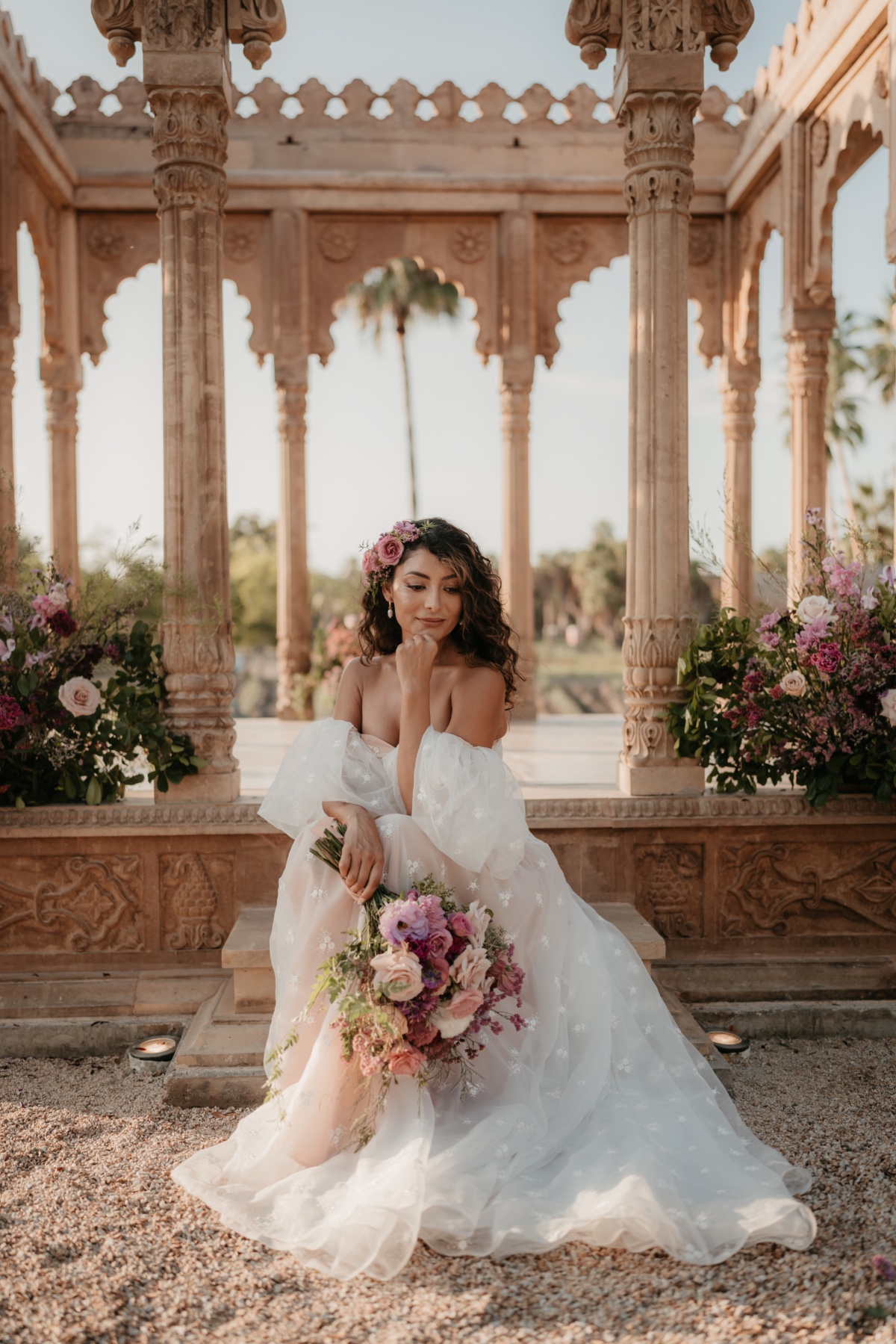 bride in blush wedding dress with flowers in hair