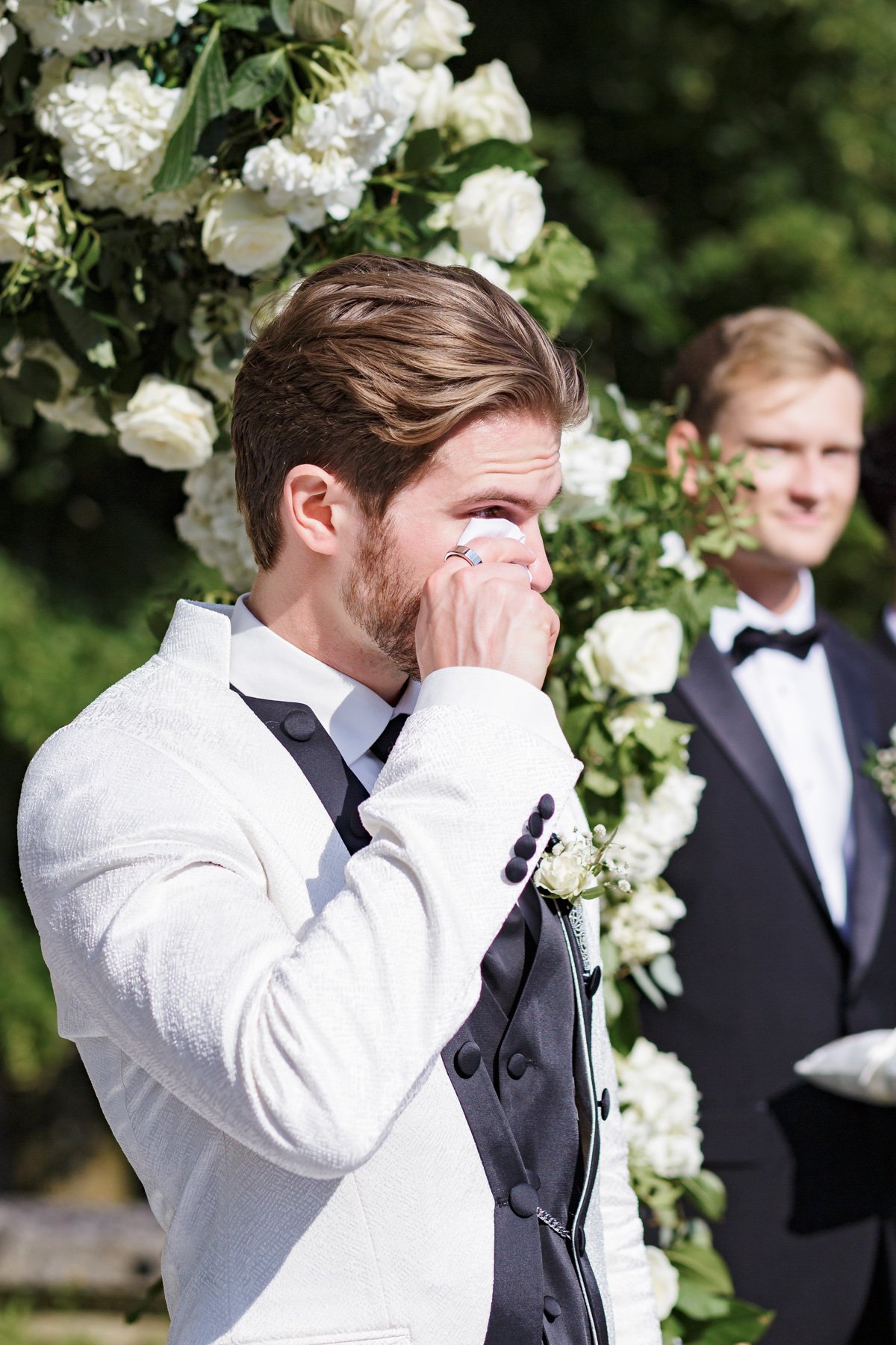 groom tearing up at wedding ceremony