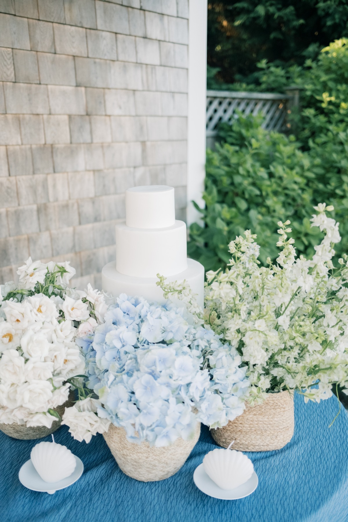 wedding cake table with blue hydrangeas