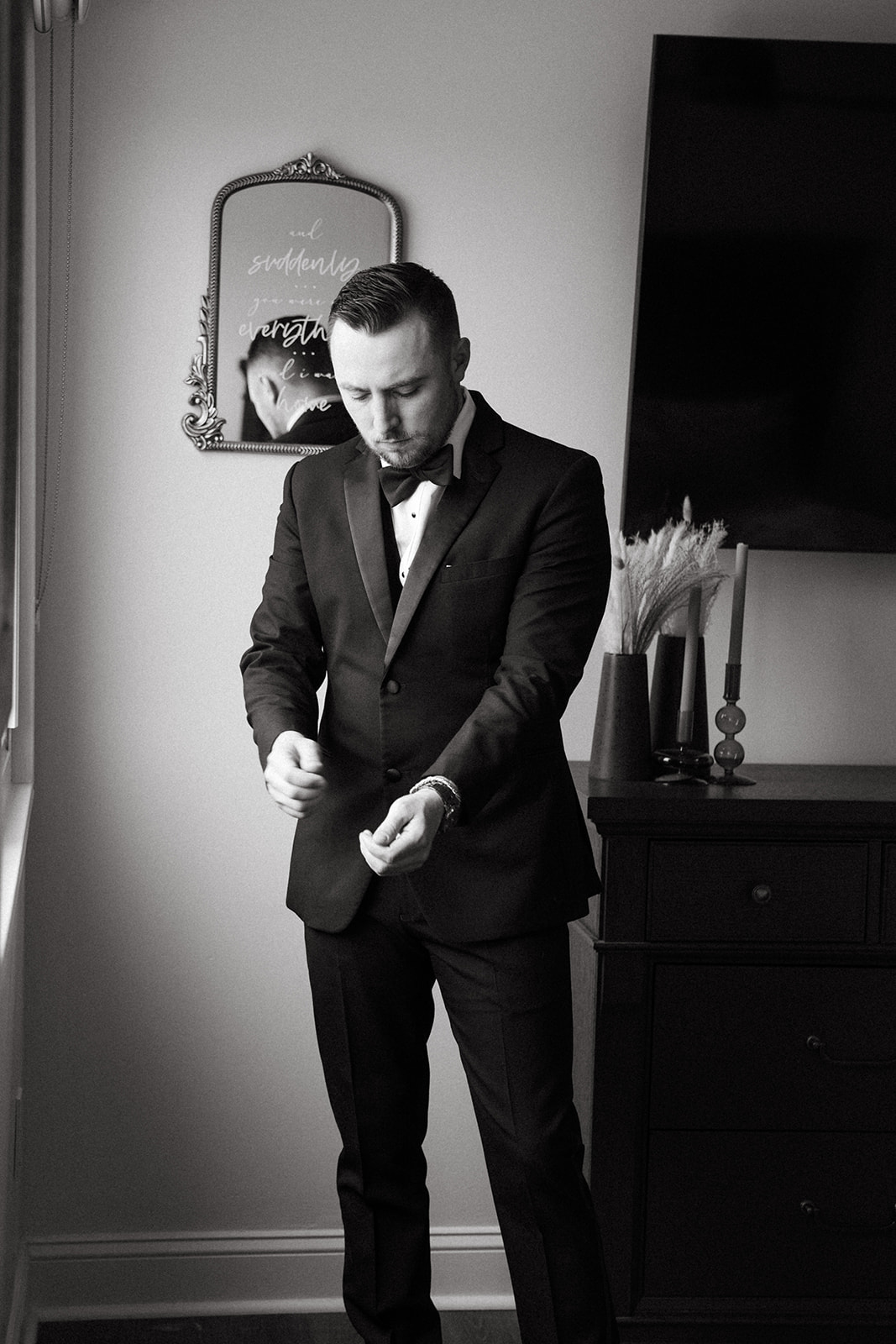 groom getting ready in tuxedo for black-tie wedding