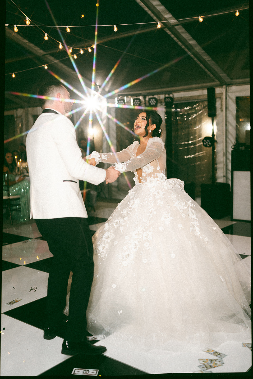 bride and groom dancing on black and white checkered dance floor