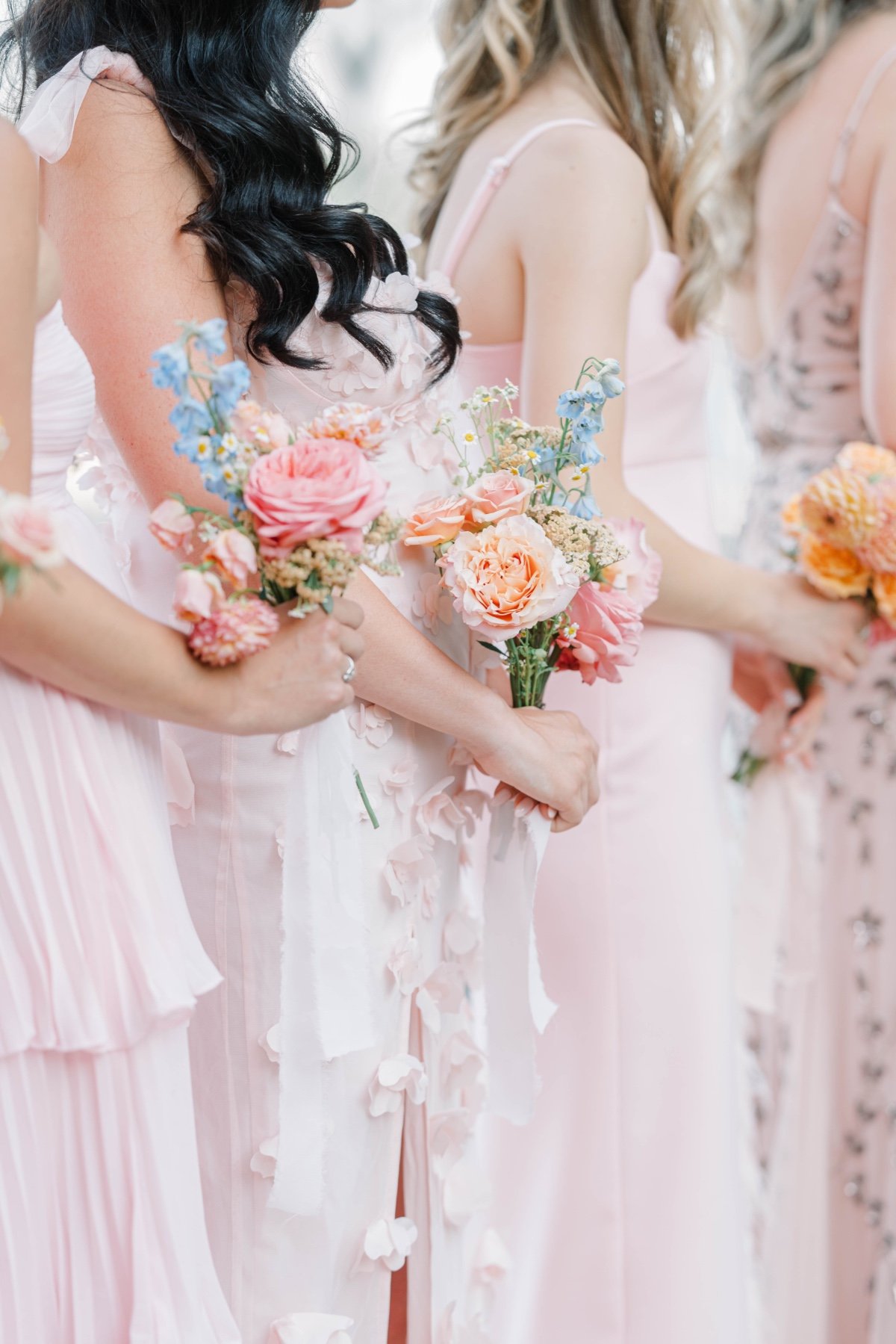 mix and match blush bridesmaid dresses with pastel bouquets