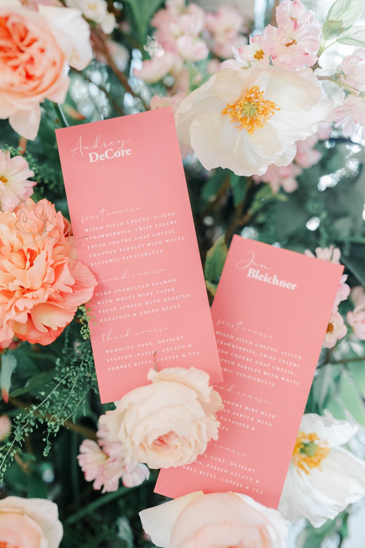 pastel wedding flower arrangements with coral menus