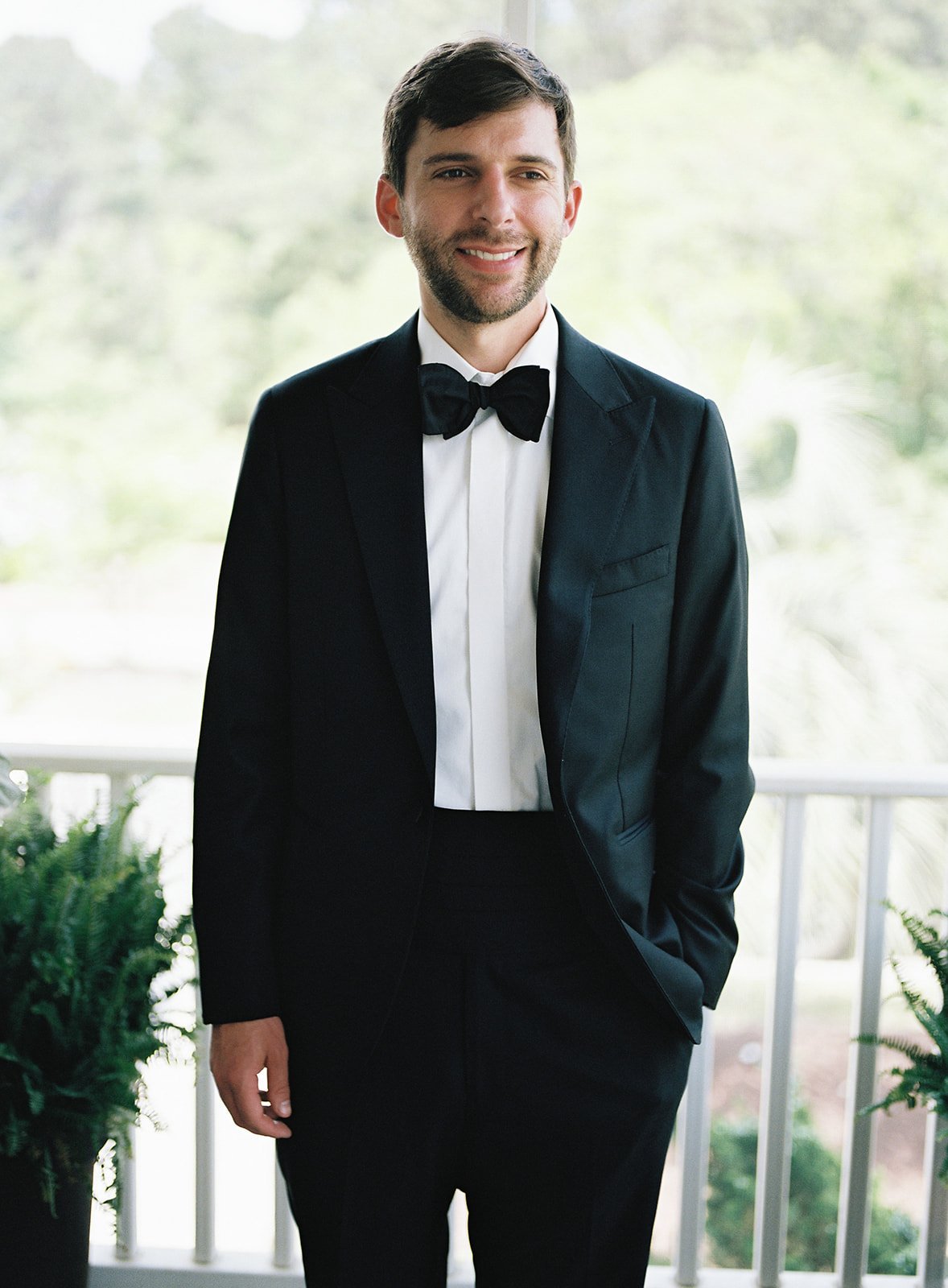 groom in black tuxedo