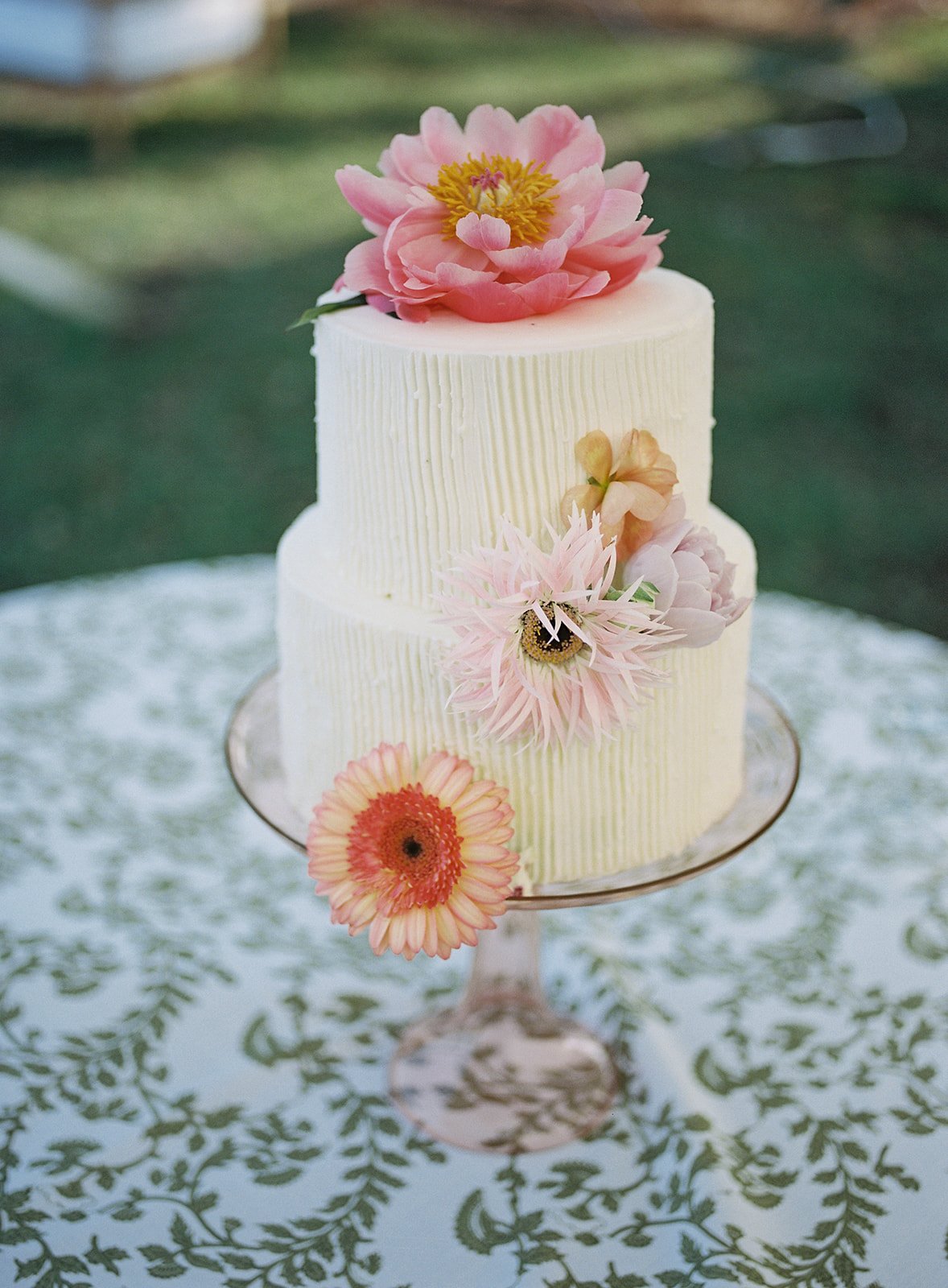 simple butter cream wedding cake with fresh flowers