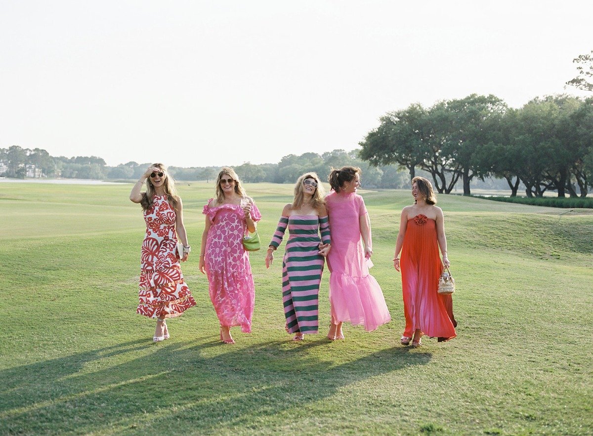 wedding guests in brightly colored dresses