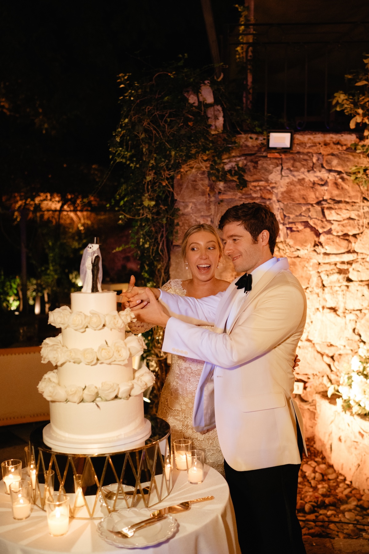 bride and groom cut wedding cake with day of the dead topper