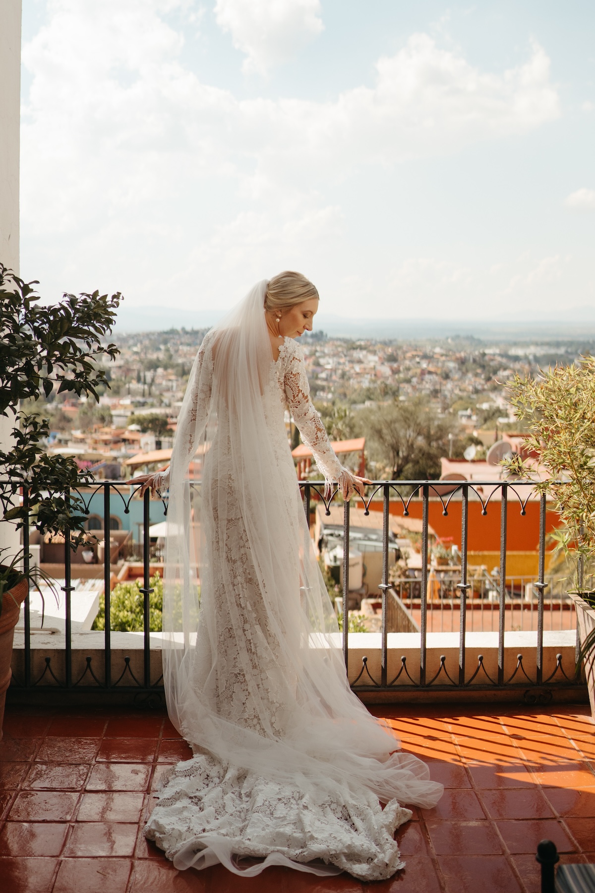 bride on balcony in mexico getting ready for wedding