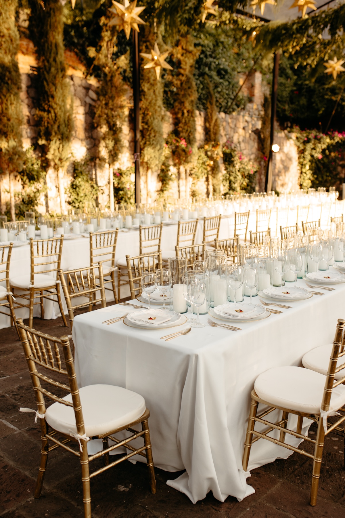 wedding reception in mexico with greenery and lanterns