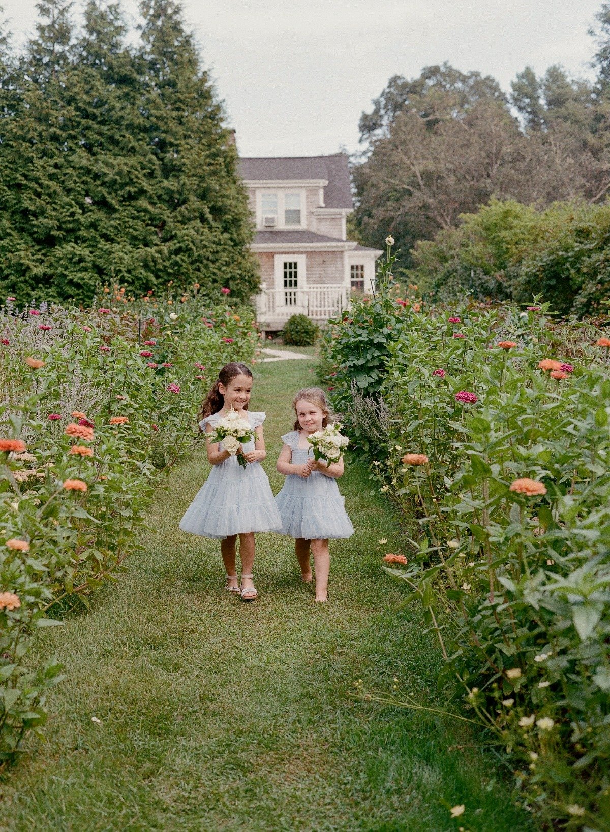 flower girls in blue tulle dresses with wildflowers