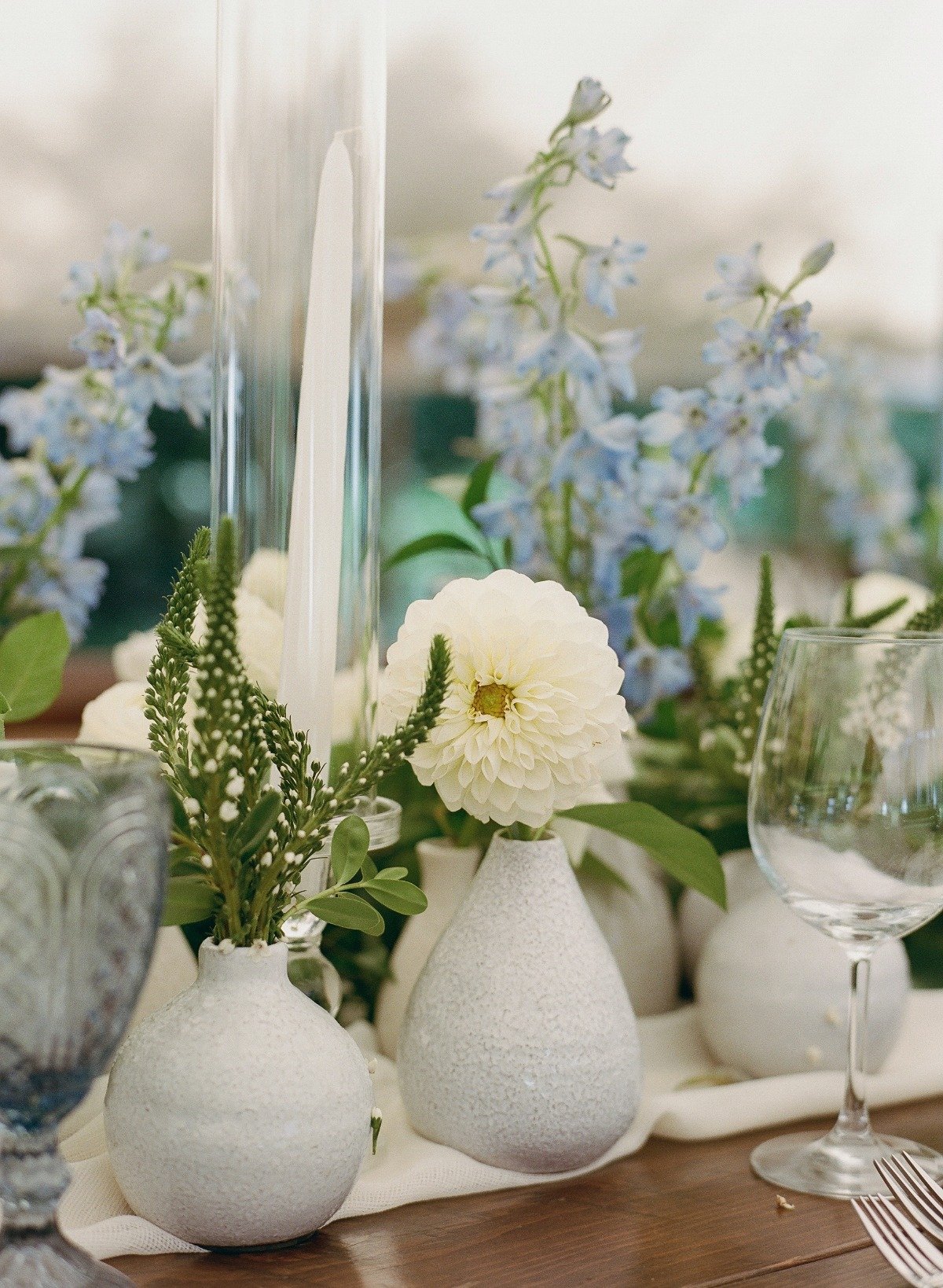 blue and white flowers in bud vases for wedding reception