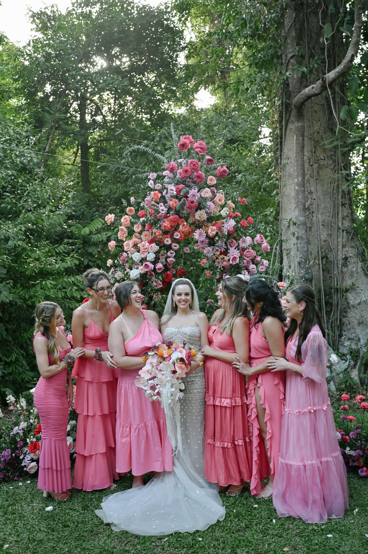 Bride and pink bridesmaids with stunning florals