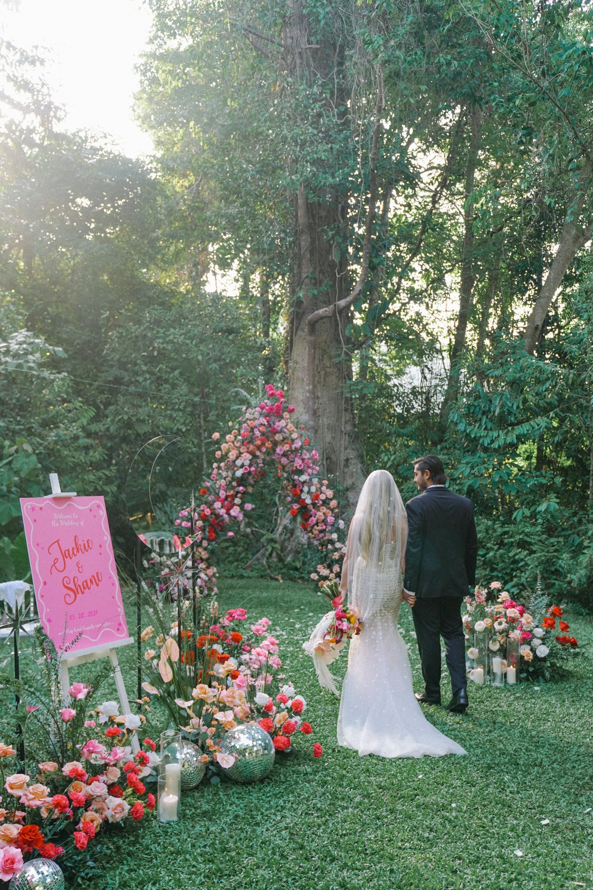 boho pink couple taking in all the sights and feels of their wedding decor