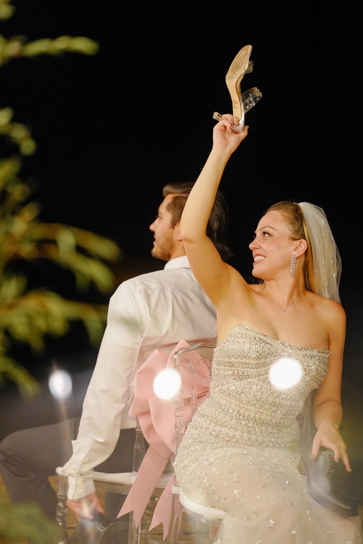 couple dancing on chairs with shoes in the air