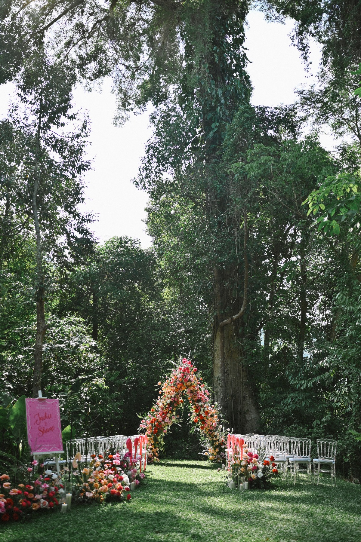 Forested Wedding Ceremony With Pink and Orange Flowers