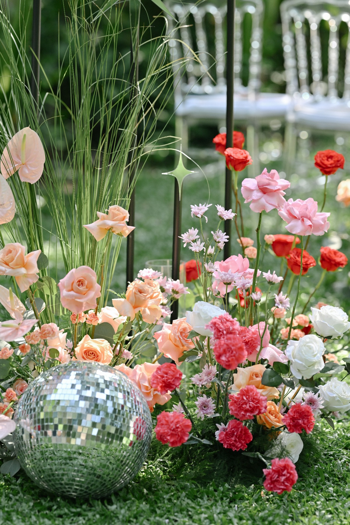 Disco Balls and Pink Flowers Line The Wedding Aisle