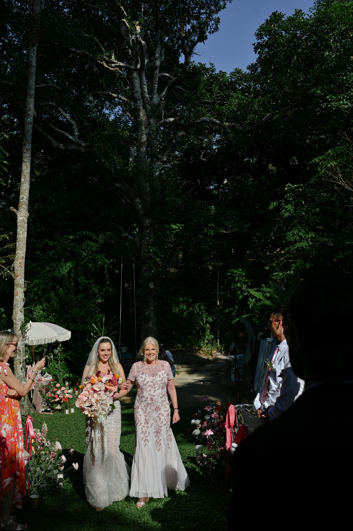 Mother of the bride walking bride down the wedding aisle