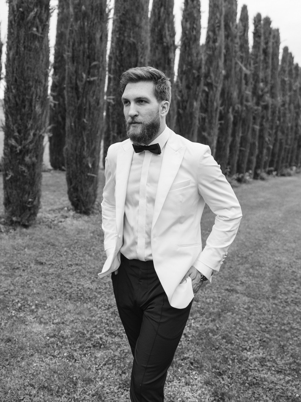 groom in white dinner jacket at black tie wedding