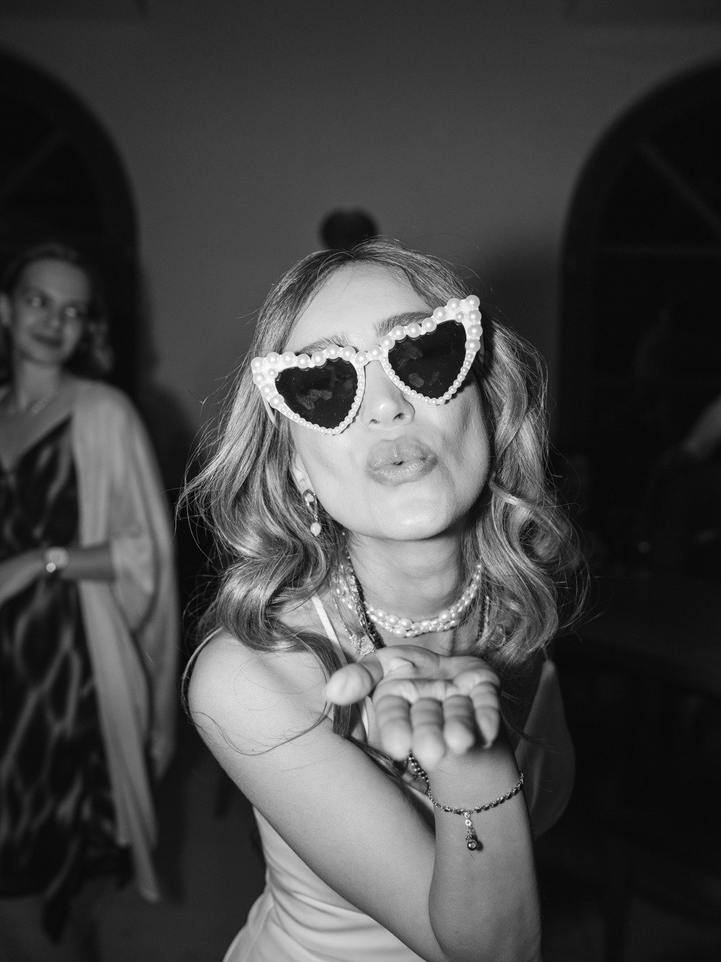 bride at reception with heart shaped sunglasses