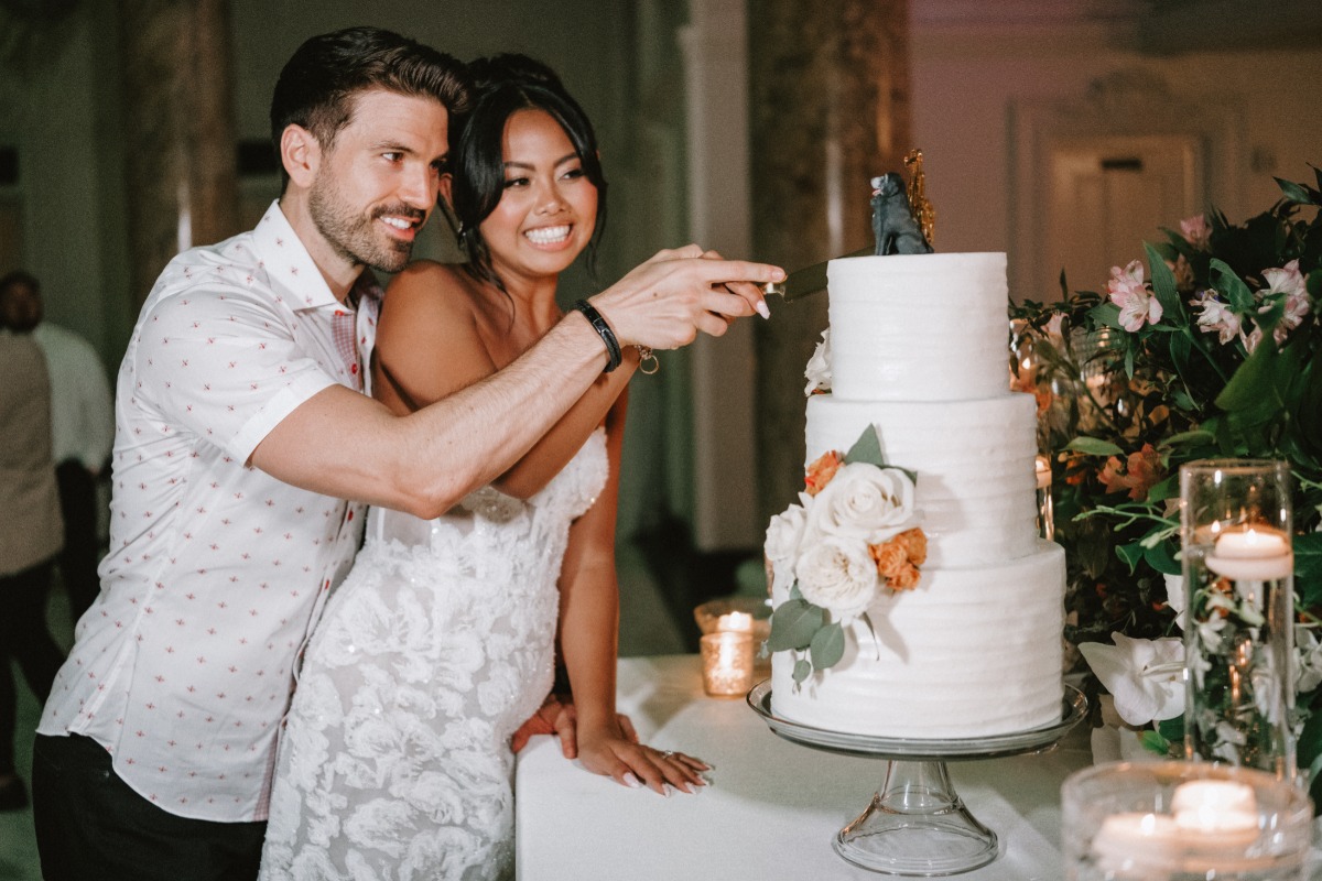 bride and groom cut wedding cake