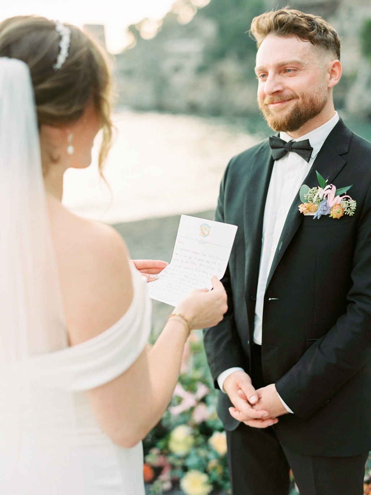 bride and groom exchanging vows at seaside elopement ceremony