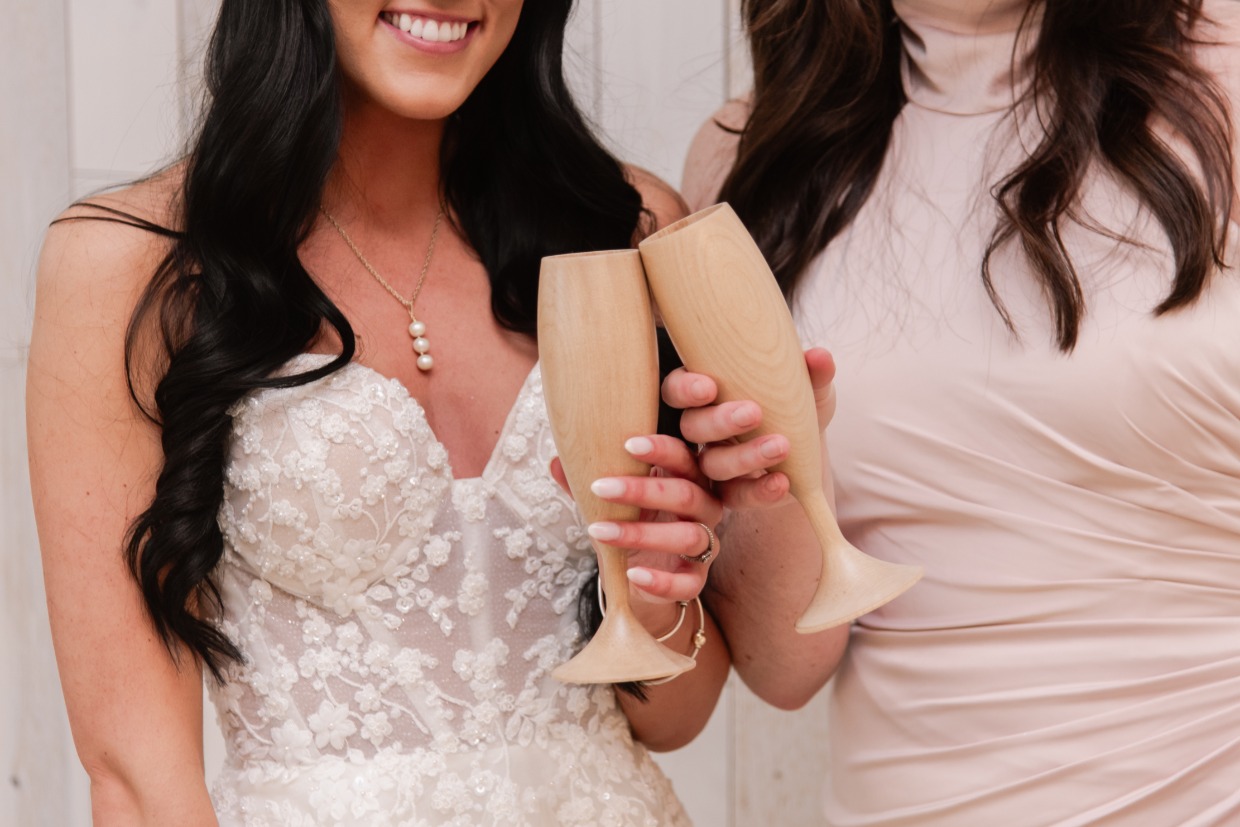 bride and bridesmaids toasting with light wood wine glass