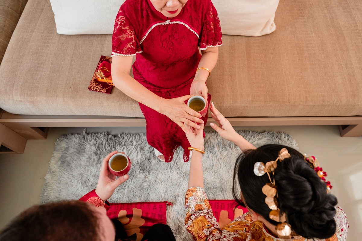 mother in red at chinese tea ceremony