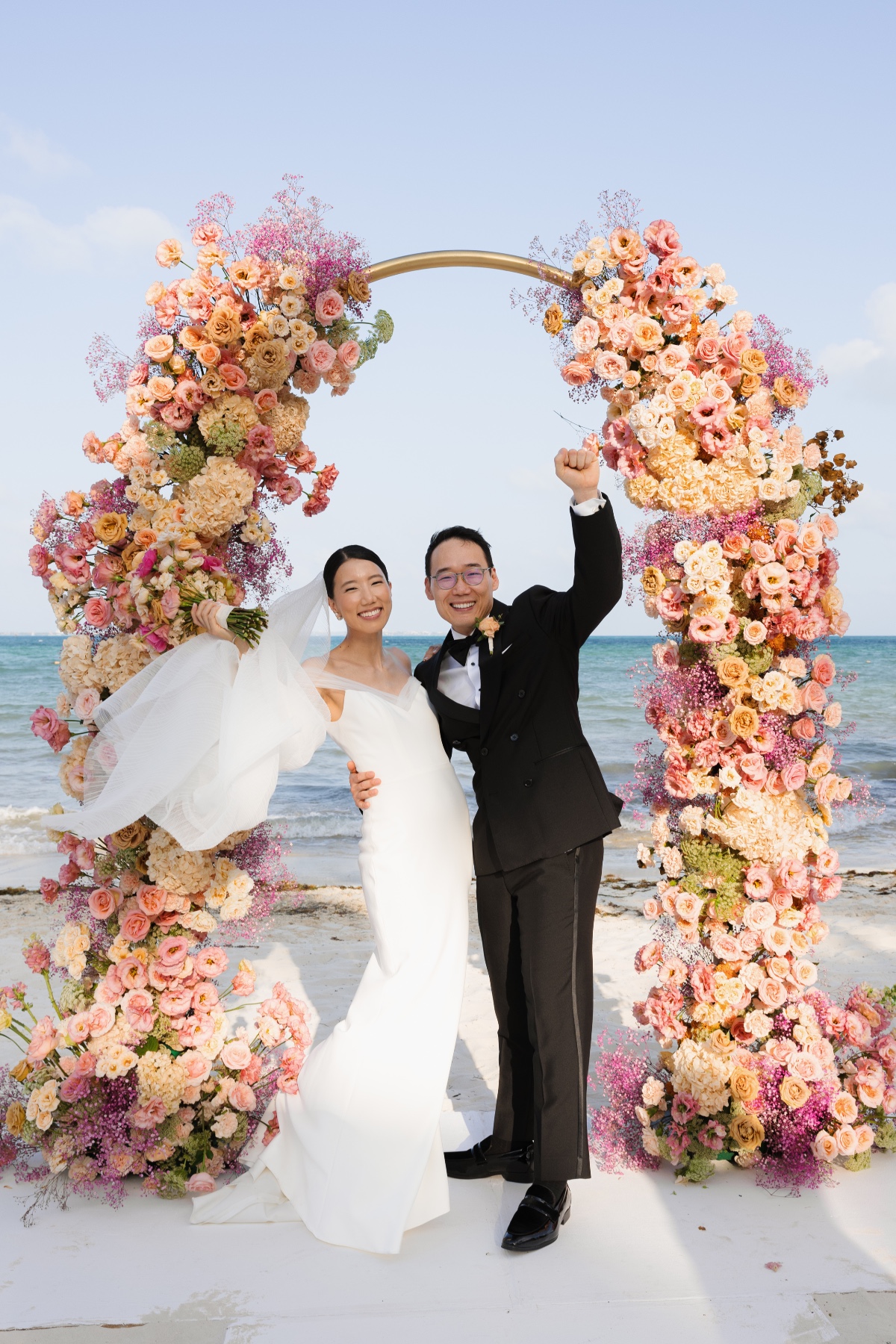 blush and peach floral arch for wedding ceremony with little greenery